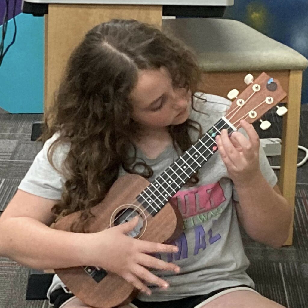 Sand Springs Education Foundation - Elementary Student Practicing Ukulele Chord